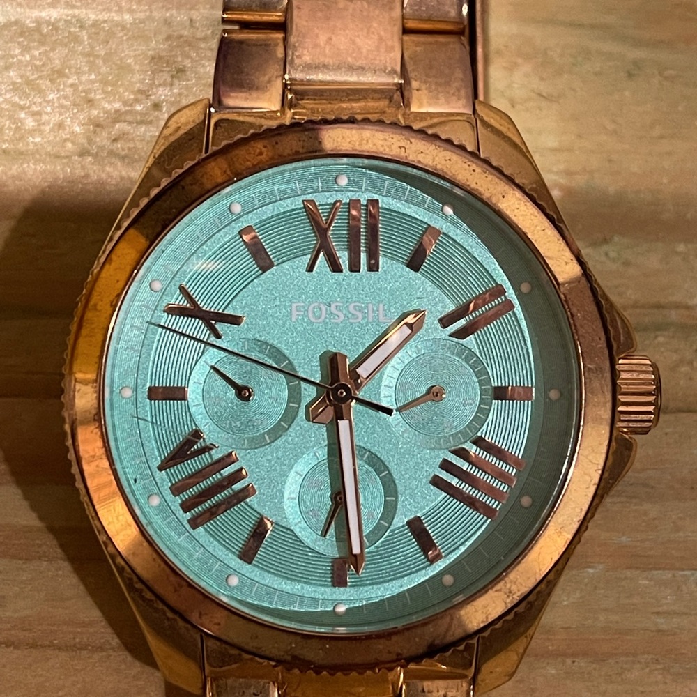 Gold Tone Fossil watch with Turquoise background on dial.